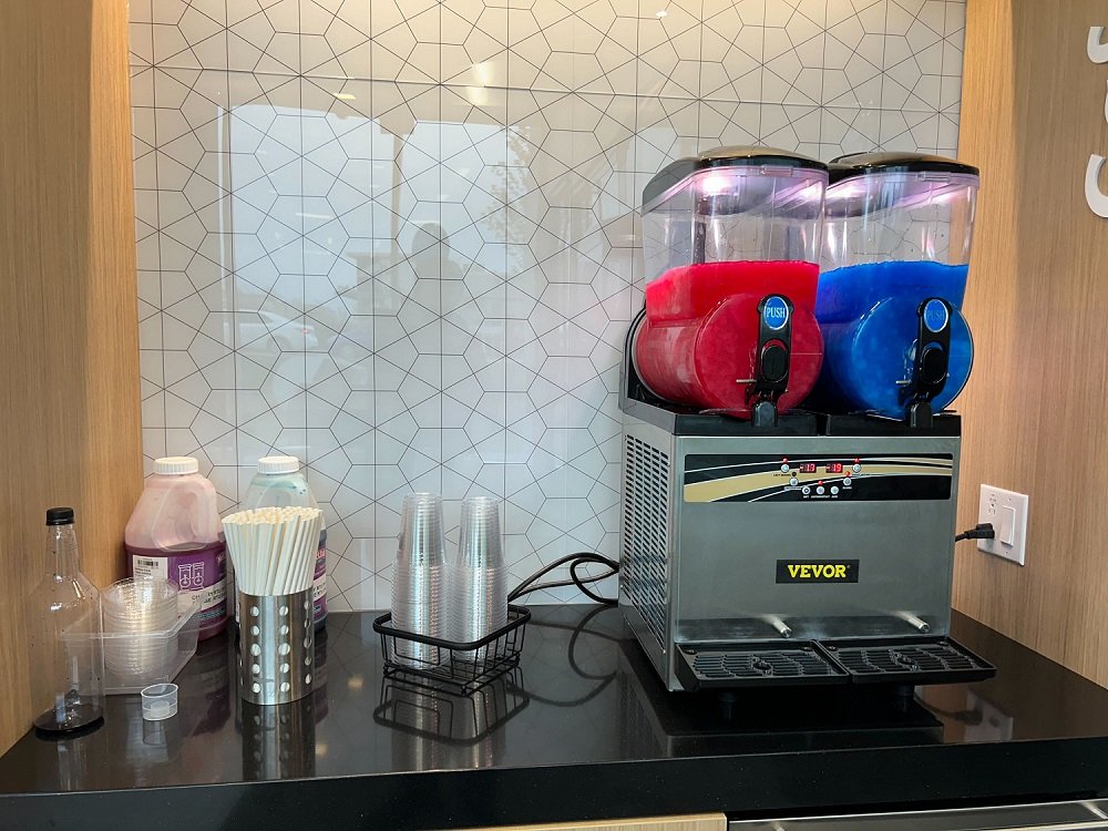 Sizzle branded slush machine pouring two frozen flavours at a Montreal event