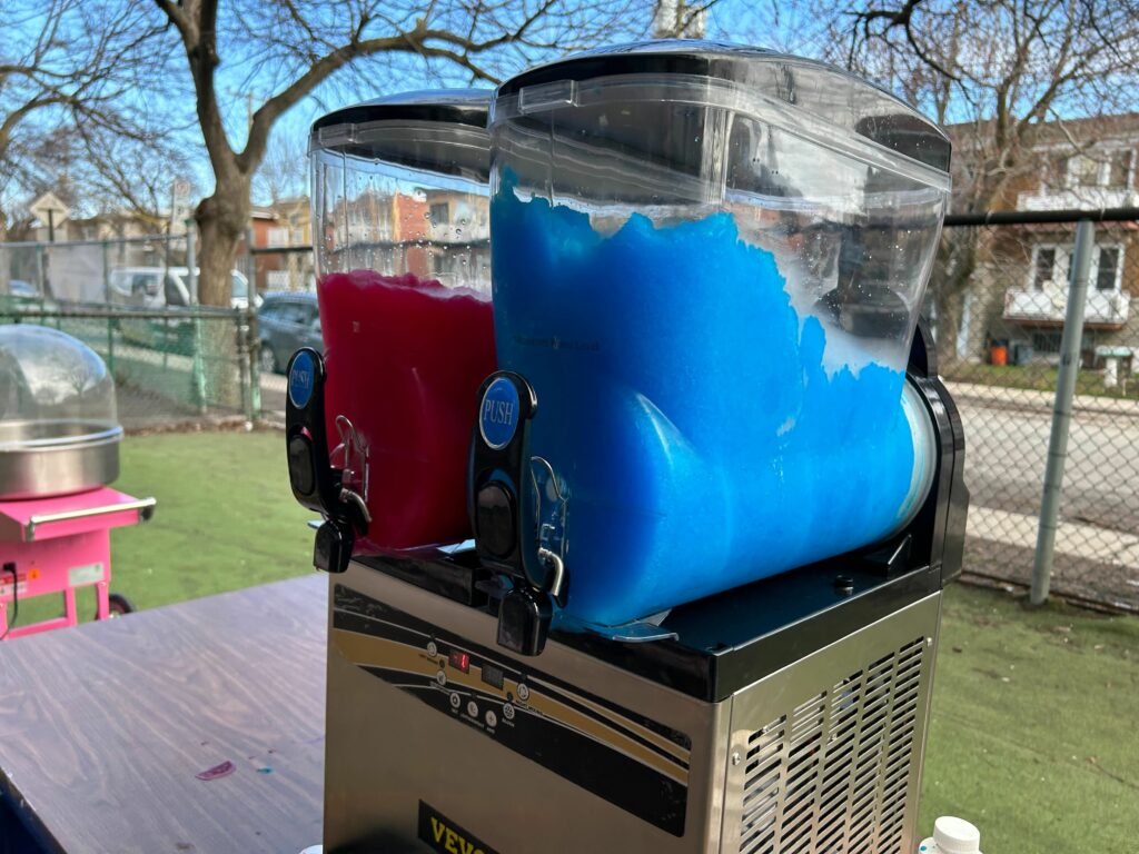 Blue and red slush machine set up at an outdoor Montreal event